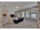 Bright living room with neutral walls, large windows, and sliding glass door at 32628 Harmony Oaks Dr, Wesley Chapel, FL 33545