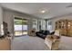 Comfortable living room with sliding glass doors to backyard and a large cabinet at 32628 Harmony Oaks Dr, Wesley Chapel, FL 33545