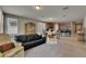 Living room featuring a black leather couch, beige chairs, and an open floor plan at 32628 Harmony Oaks Dr, Wesley Chapel, FL 33545
