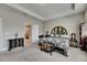 Spacious main bedroom featuring tray ceilings, ensuite bath and unique decor at 32628 Harmony Oaks Dr, Wesley Chapel, FL 33545