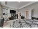 Bright main bedroom featuring neutral walls, ensuite bath and large media center at 32628 Harmony Oaks Dr, Wesley Chapel, FL 33545