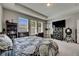 Bright main bedroom featuring neutral walls, large media center and exterior view at 32628 Harmony Oaks Dr, Wesley Chapel, FL 33545