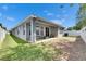 View of the covered patio with seating; perfect for outdoor relaxation at 32628 Harmony Oaks Dr, Wesley Chapel, FL 33545