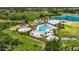 Aerial view featuring a luxurious pool area and splash pad at 32628 Harmony Oaks Dr, Wesley Chapel, FL 33545