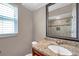 Bathroom with granite vanity and shower featuring attractive tile and a window at 3439 Northridge Dr, Clearwater, FL 33761