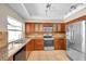 Updated kitchen featuring stainless steel appliances, granite counters and wood cabinets at 3439 Northridge Dr, Clearwater, FL 33761