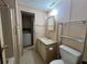Bathroom featuring a vanity, mirror, toilet and shower/tub at 35804 Brisa Dr, Zephyrhills, FL 33541