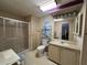 Bathroom featuring a shower stall, toilet, sink with vanity and tiled floors at 35804 Brisa Dr, Zephyrhills, FL 33541