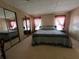 Bedroom featuring carpet floors, ample natural light, and large closet space at 35804 Brisa Dr, Zephyrhills, FL 33541
