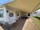 Exterior view of the home's carport, front entrance, and golf cart at 35804 Brisa Dr, Zephyrhills, FL 33541