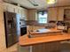 Functional kitchen featuring updated stainless-steel appliances and generous counter space at 35804 Brisa Dr, Zephyrhills, FL 33541