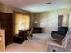 Cozy living room featuring carpeted floors, a desk, and comfortable seating furniture at 35804 Brisa Dr, Zephyrhills, FL 33541