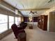 Spacious living room featuring carpeted floors, comfortable seating, and large windows at 35804 Brisa Dr, Zephyrhills, FL 33541