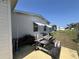 View of home's patio with picnic table, awning, and green space at 35804 Brisa Dr, Zephyrhills, FL 33541