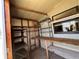 Shed featuring shelving, storage, work table, and window at 35804 Brisa Dr, Zephyrhills, FL 33541