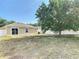 Backyard with large tree, patio, and fenced perimeter; an ideal outdoor space for entertaining and relaxation at 36144 Markree Castle Ave, Dade City, FL 33525