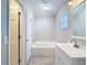 Bright bathroom with a soaking tub, vanity, and neutral finishes at 36144 Markree Castle Ave, Dade City, FL 33525