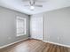 Bedroom featuring wood floors, natural light, and a double-door closet at 36144 Markree Castle Ave, Dade City, FL 33525