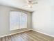 Sun-filled bedroom with wood floors and a large window at 36144 Markree Castle Ave, Dade City, FL 33525