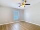Bright bedroom featuring light, neutral walls, and modern wood flooring at 36144 Markree Castle Ave, Dade City, FL 33525