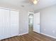 Bedroom with wood floors and a door leading to the rest of the home at 36144 Markree Castle Ave, Dade City, FL 33525