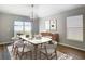 Contemporary dining room featuring modern light fixture, wood floors, and sliding glass doors at 36144 Markree Castle Ave, Dade City, FL 33525