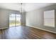 Dining area features hardwood floors, natural light from a sliding door, and modern chandelier, perfect for gatherings at 36144 Markree Castle Ave, Dade City, FL 33525