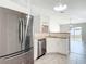 Eat-in kitchen with stainless steel appliances, butcher block counters, and white cabinets; open to dining area at 36144 Markree Castle Ave, Dade City, FL 33525