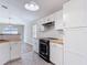 Renovated kitchen featuring white cabinetry, stainless steel appliances, and butcher block countertops at 36144 Markree Castle Ave, Dade City, FL 33525