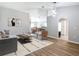 Comfortable living area with wood-look floors, neutral decor, connecting seamlessly to the dining area at 36144 Markree Castle Ave, Dade City, FL 33525