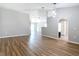 Hardwood floors complement an airy living room, seamlessly connected to other living spaces for a fluid, modern feel at 36144 Markree Castle Ave, Dade City, FL 33525
