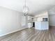 Open-concept living area with a modern light fixture and seamless flow into the kitchen at 36144 Markree Castle Ave, Dade City, FL 33525