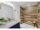 Stylish bathroom featuring wood-look tiled shower with mosaic accents and granite countertop at 3622 Tamarix Dr, Tampa, FL 33619