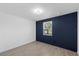 Inviting bedroom with wood-look flooring and a calming blue accent wall at 3622 Tamarix Dr, Tampa, FL 33619
