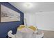 Dining room features contemporary decor, a striking blue accent wall, and an ocean-themed artwork at 3622 Tamarix Dr, Tampa, FL 33619