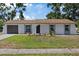 Charming single-story home featuring a well-manicured lawn and a quaint front garden at 3622 Tamarix Dr, Tampa, FL 33619