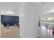 Spacious hallway with wood-look floors leading to an open layout dining and living room at 3622 Tamarix Dr, Tampa, FL 33619