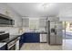 Modern kitchen showcasing stainless steel appliances, granite countertops, and stylish gray cabinetry at 3622 Tamarix Dr, Tampa, FL 33619