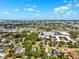 The aerial view showcases a cityscape blending residential and commercial areas with lush greenery at 3914 W Cleveland St, Tampa, FL 33609