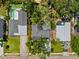An aerial view shows the layout of the houses, their yards, and surrounding lush landscaping at 3914 W Cleveland St, Tampa, FL 33609