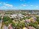 Expansive aerial view of a vibrant neighborhood featuring lush greenery and clear blue skies at 3914 W Cleveland St, Tampa, FL 33609