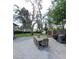Spacious backyard patio with outdoor seating, grilling area, mature trees, and grass at 3914 W Cleveland St, Tampa, FL 33609