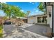 Spacious backyard patio with a large dining table, grill, and sliding door access to the home at 3914 W Cleveland St, Tampa, FL 33609