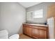 Bathroom features wood cabinets, granite countertops, updated fixtures and natural light at 3914 W Cleveland St, Tampa, FL 33609