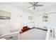 Bright Bedroom with white walls, wood floors, soft chair, dresser, and a crib at 3914 W Cleveland St, Tampa, FL 33609