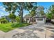 Charming home with a well-manicured lawn, mature trees, and a long driveway at 3914 W Cleveland St, Tampa, FL 33609