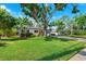Charming home with a well-manicured lawn and mature trees adding to curb appeal at 3914 W Cleveland St, Tampa, FL 33609