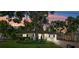 The home has charming curb appeal with a lush lawn and beautiful sunset lighting at 3914 W Cleveland St, Tampa, FL 33609