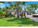Charming home with mature trees, lush lawn, and a well-kept landscape at 3914 W Cleveland St, Tampa, FL 33609