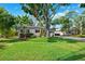 Charming home with a well-manicured lawn and mature trees enhancing its curb appeal at 3914 W Cleveland St, Tampa, FL 33609